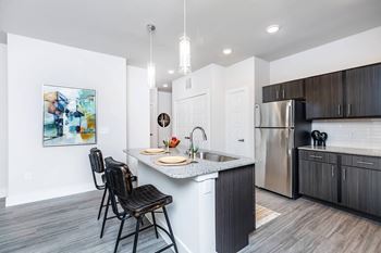 Kitchen breakfast bar with granite counter and stools
